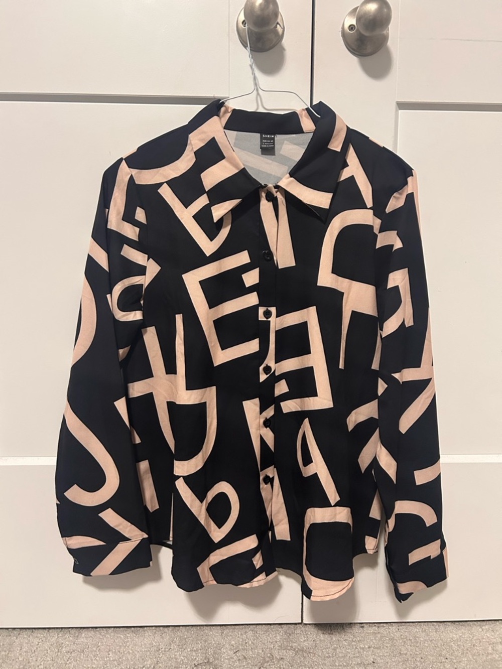 Black Button-Up Blouse with Beige Graphic Lettering